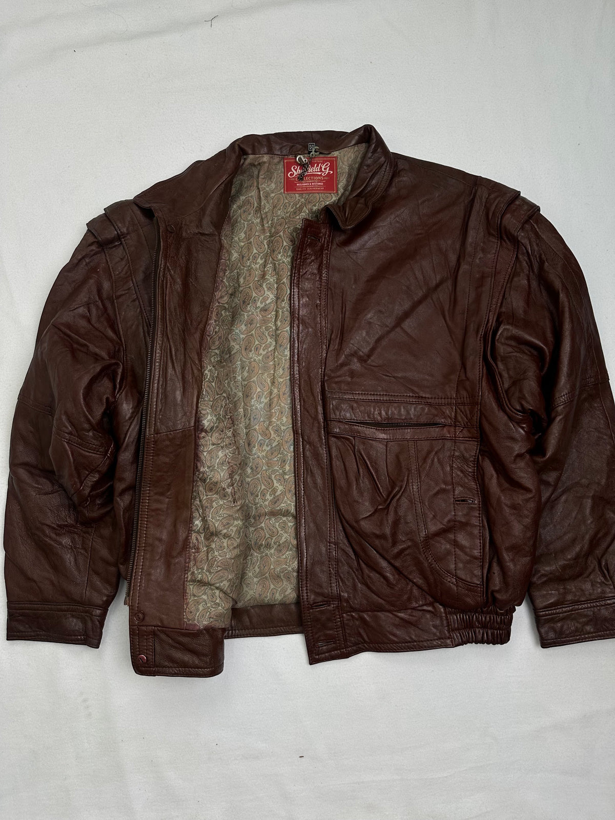 Lining of the burgundy leather harrington jacket, held open