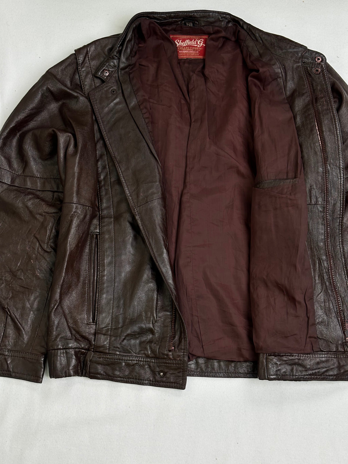 Burgundy woven lining shown with the cafe racer held open