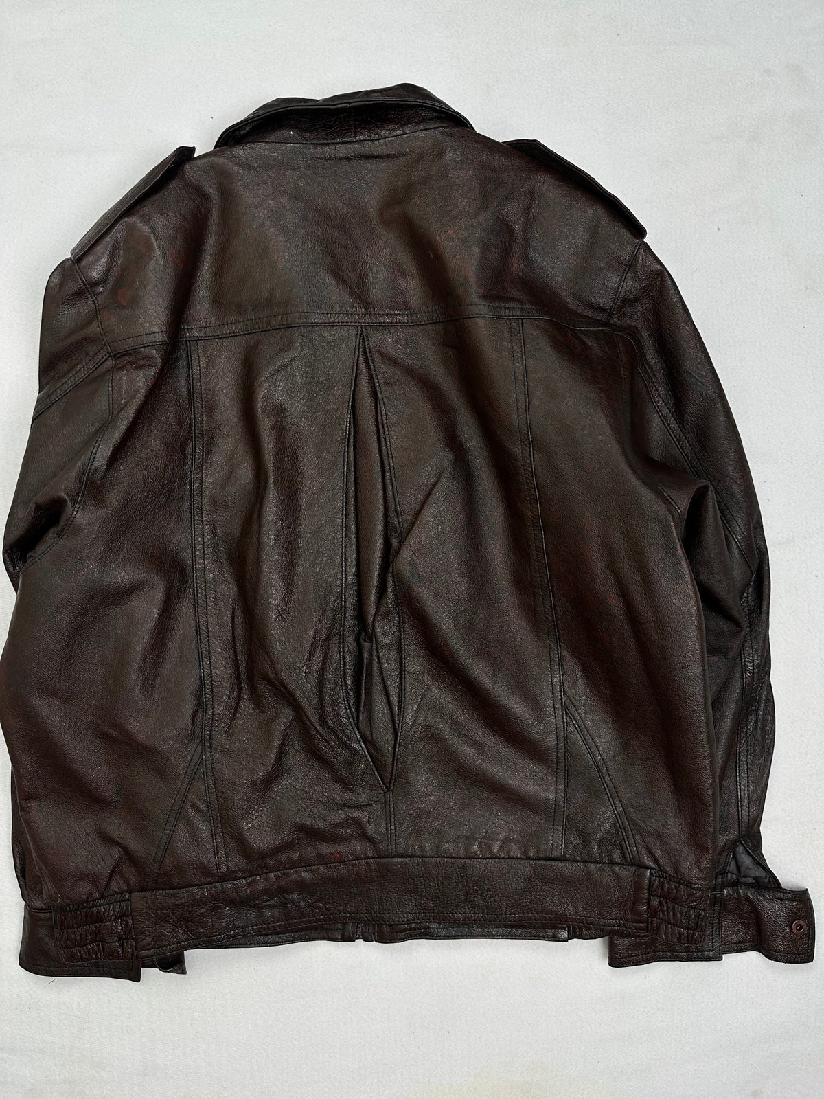 Back of the size L brown leather flight jacket, laid flat