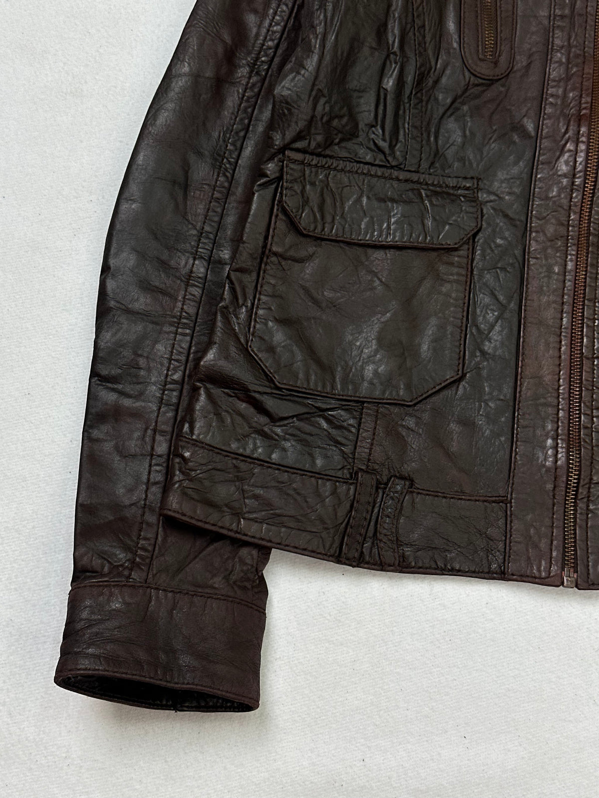 Close detail of the pockets and cuff on the size XS brown leather cafe racer jacket
