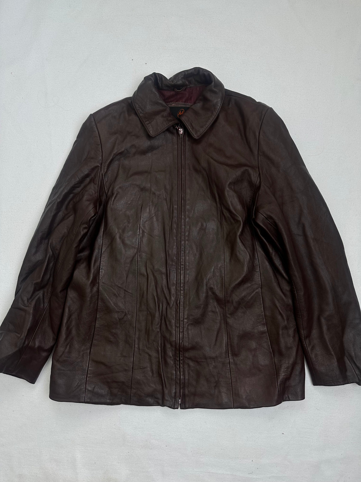 Front of the size L burgundy leather vintage jacket, laid flat and unedited