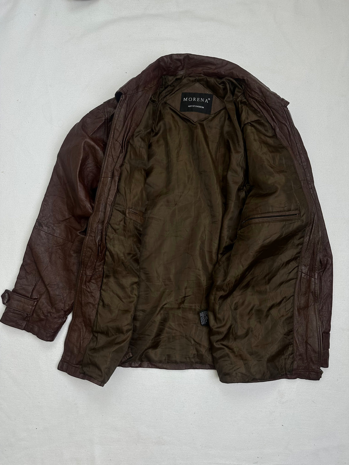 The size L burgundy leather vintage jacket opened to show the lining
