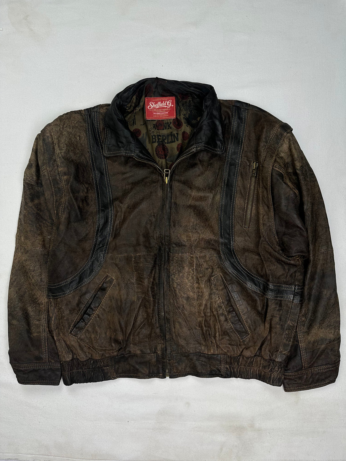 Back of the size L brown harrington jacket laid flat
