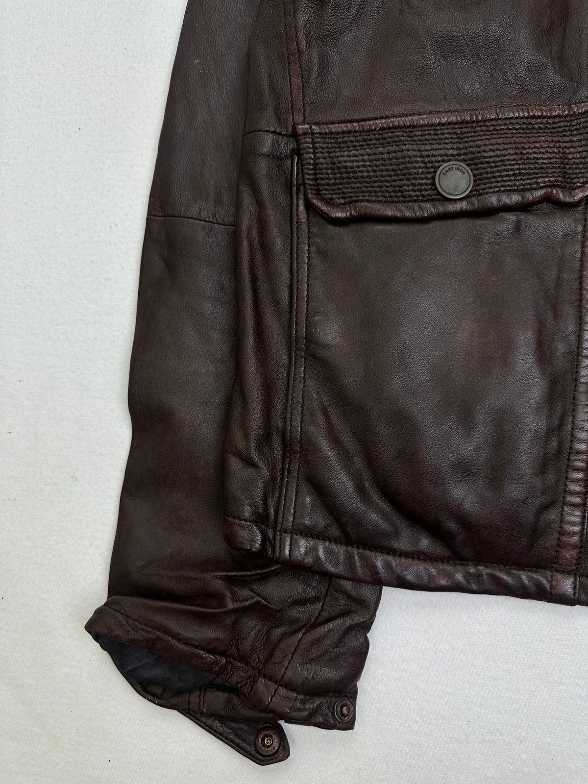 Close detail of the pockets and cuff on the size L burgundy leather field jacket