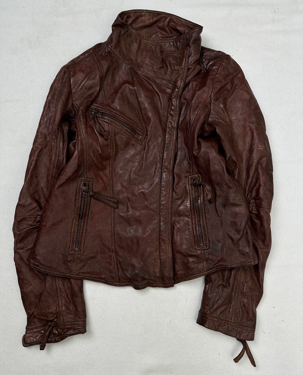 Front of the size S burgundy leather biker jacket, laid flat and unedited
