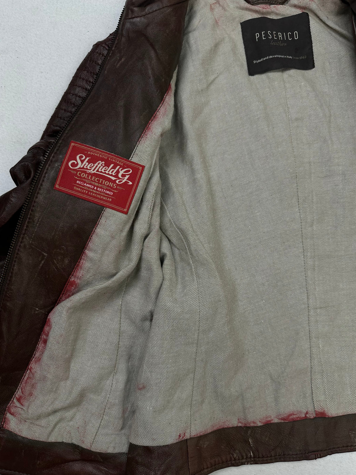 The size XS burgundy leather cafe racer jacket opened to show the lining