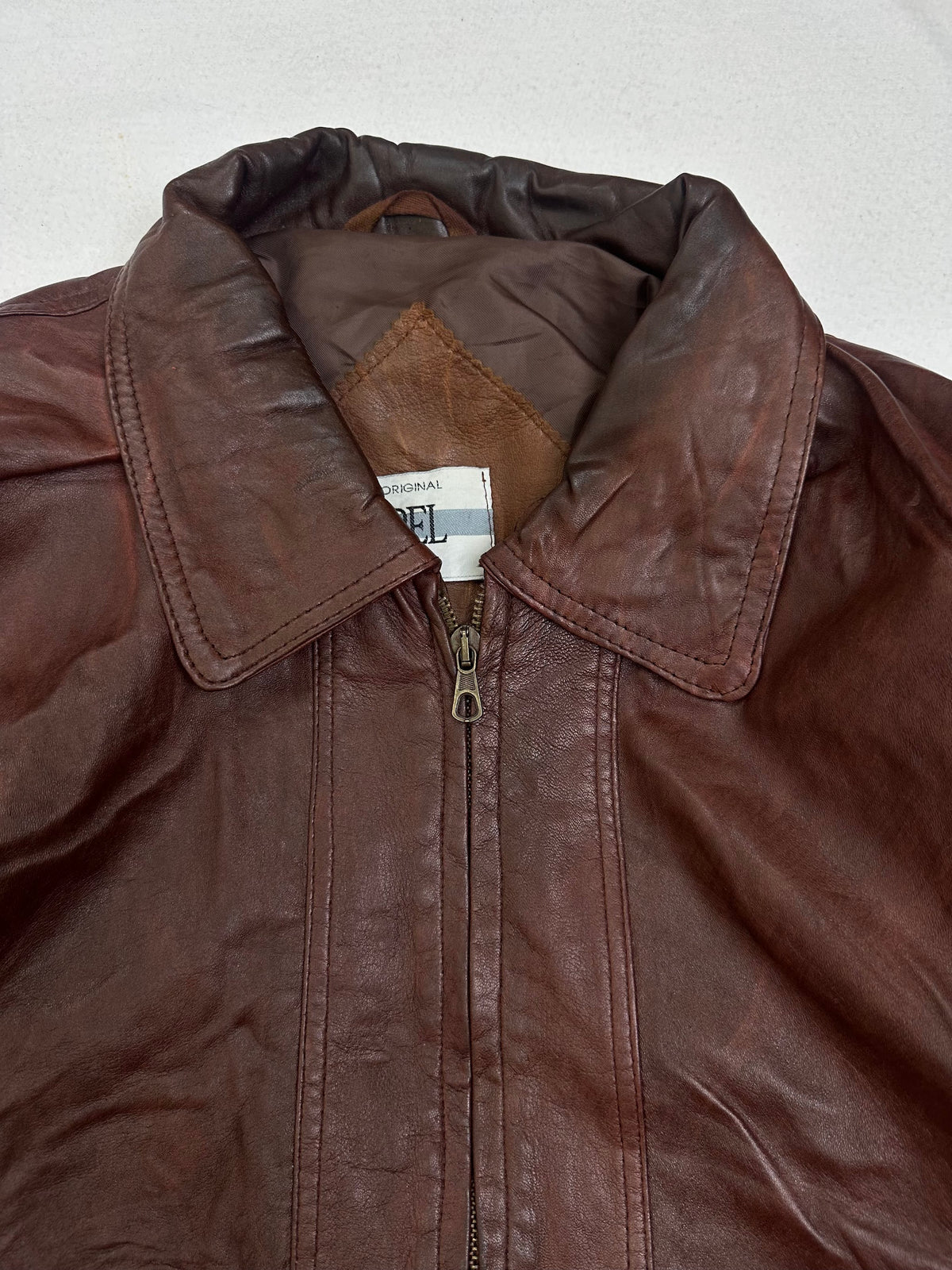 Collar and zip of the size XL burgundy leather harrington jacket, up close