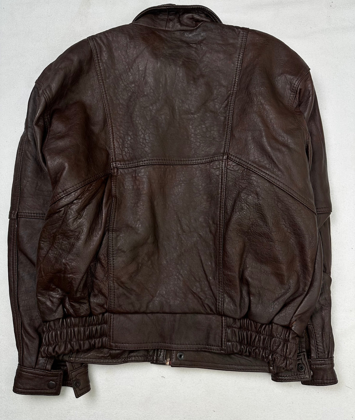 Back of the size L burgundy leather flight jacket, laid flat