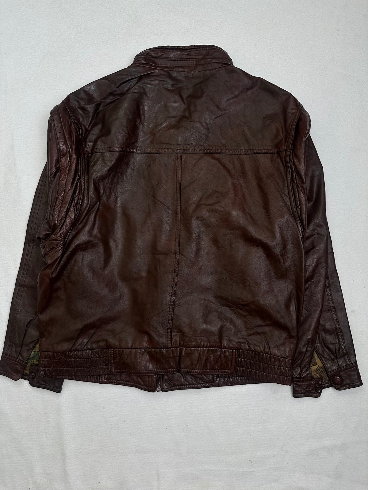 Back of the size L burgundy leather flight jacket, laid flat