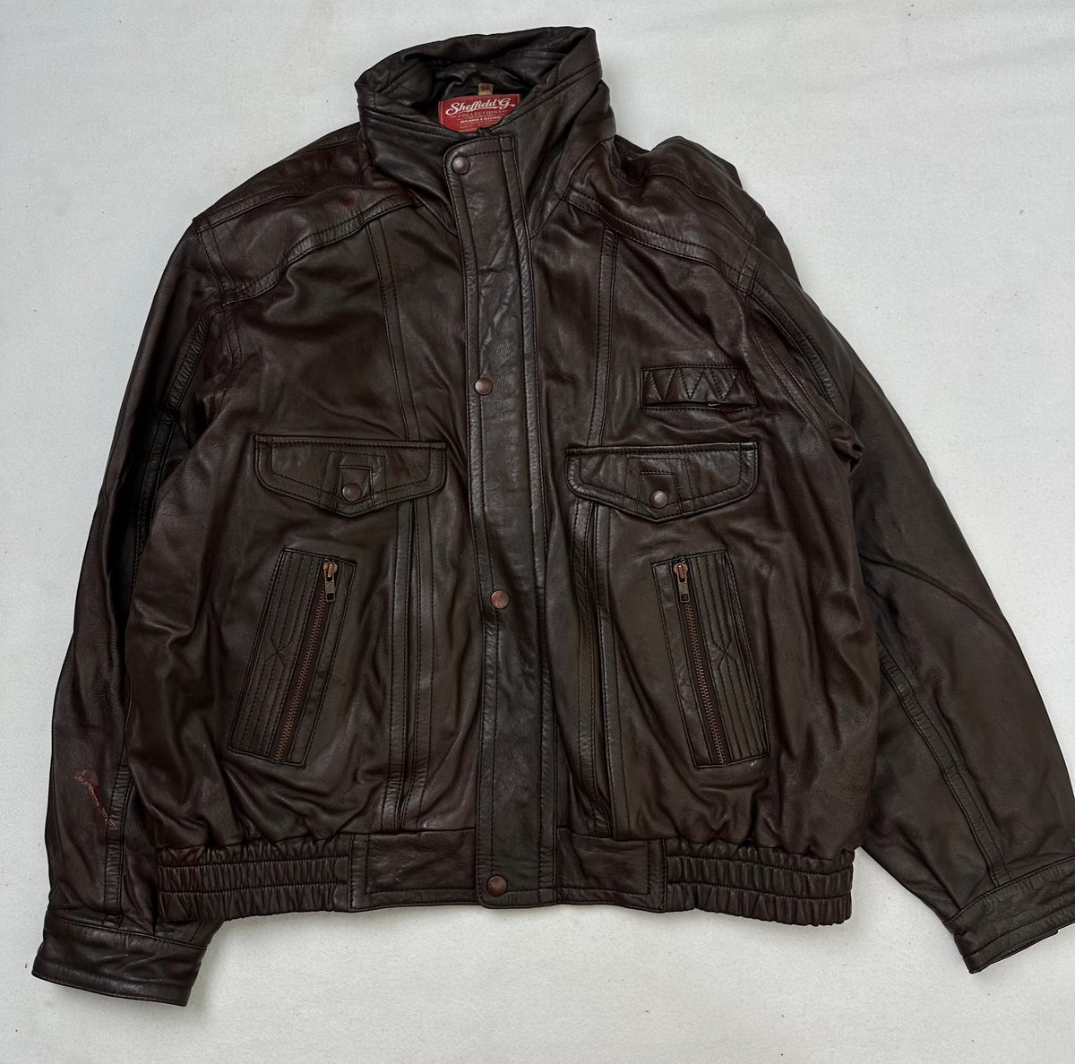 Front of the size L burgundy leather flight jacket, laid flat and unedited