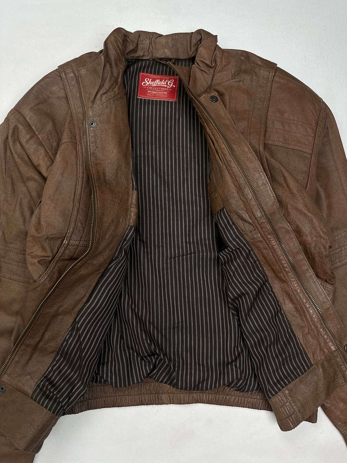 Black and off-white pinstripe lining shown with the jacket open