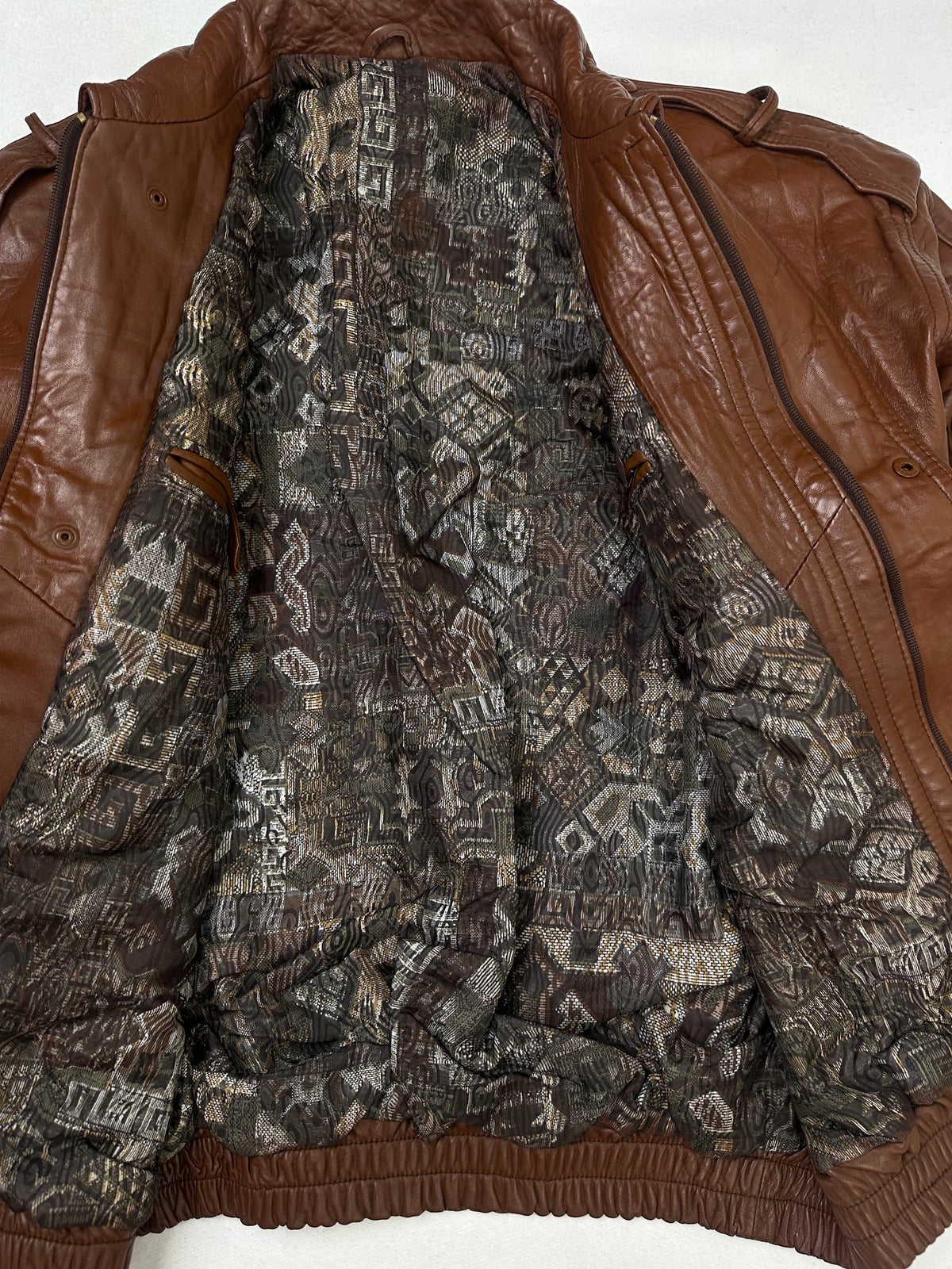 The size L brown leather flight jacket opened to show the lining