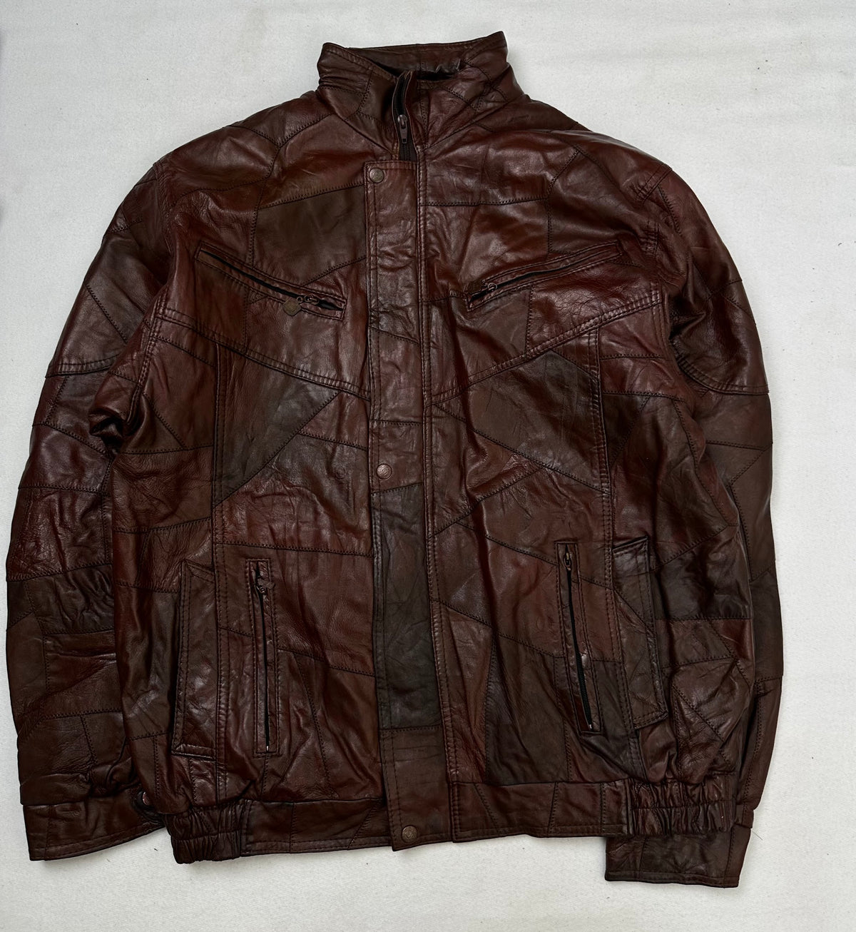 Front of the size XL burgundy leather flight jacket, laid flat and unedited
