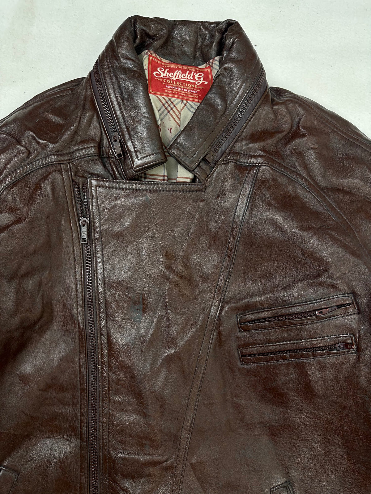 Collar and zip of the size L burgundy leather biker jacket, up close