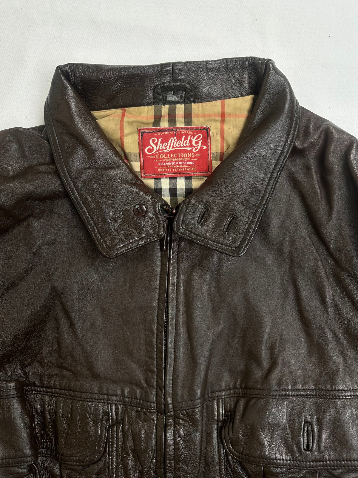 Stud flap chest pocket above a vertical zip slash pocket