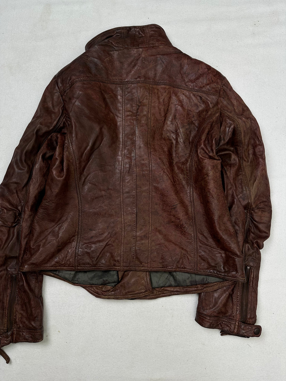 Back of the size S burgundy leather biker jacket, laid flat