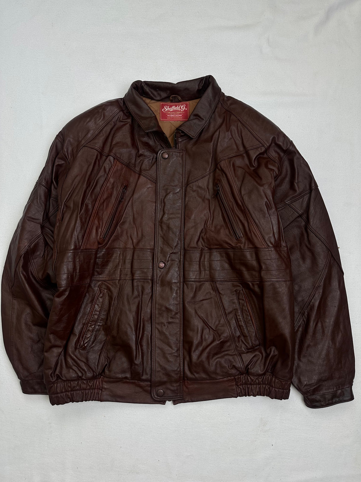Front of the size L burgundy leather vintage jacket, laid flat and unedited