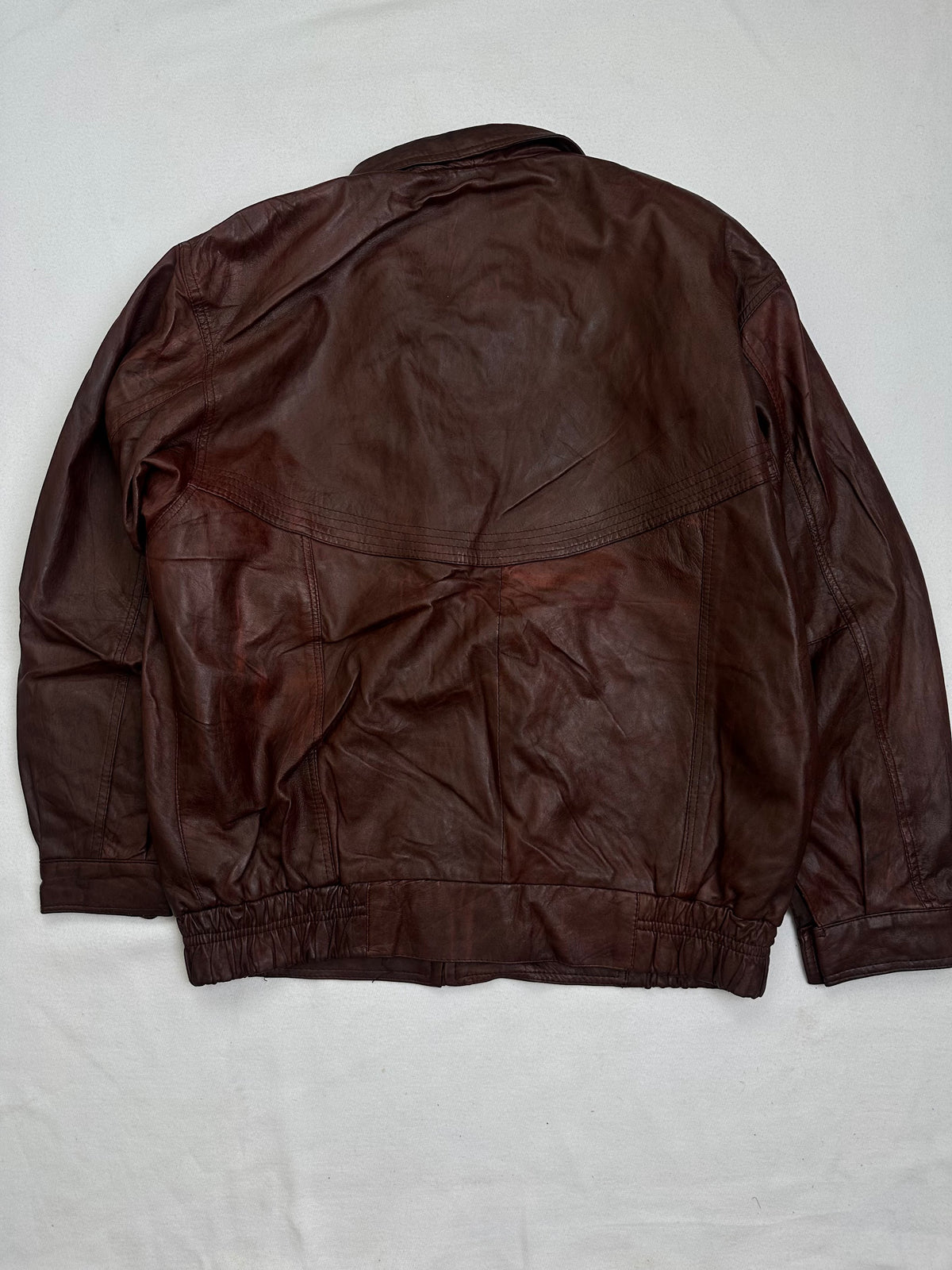 Back of the size XL burgundy leather harrington jacket, laid flat