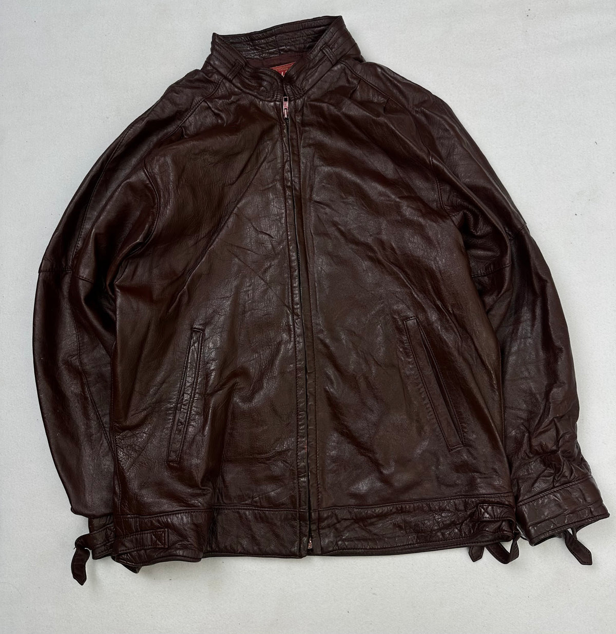 Front of the size L burgundy leather cafe racer jacket, laid flat and unedited