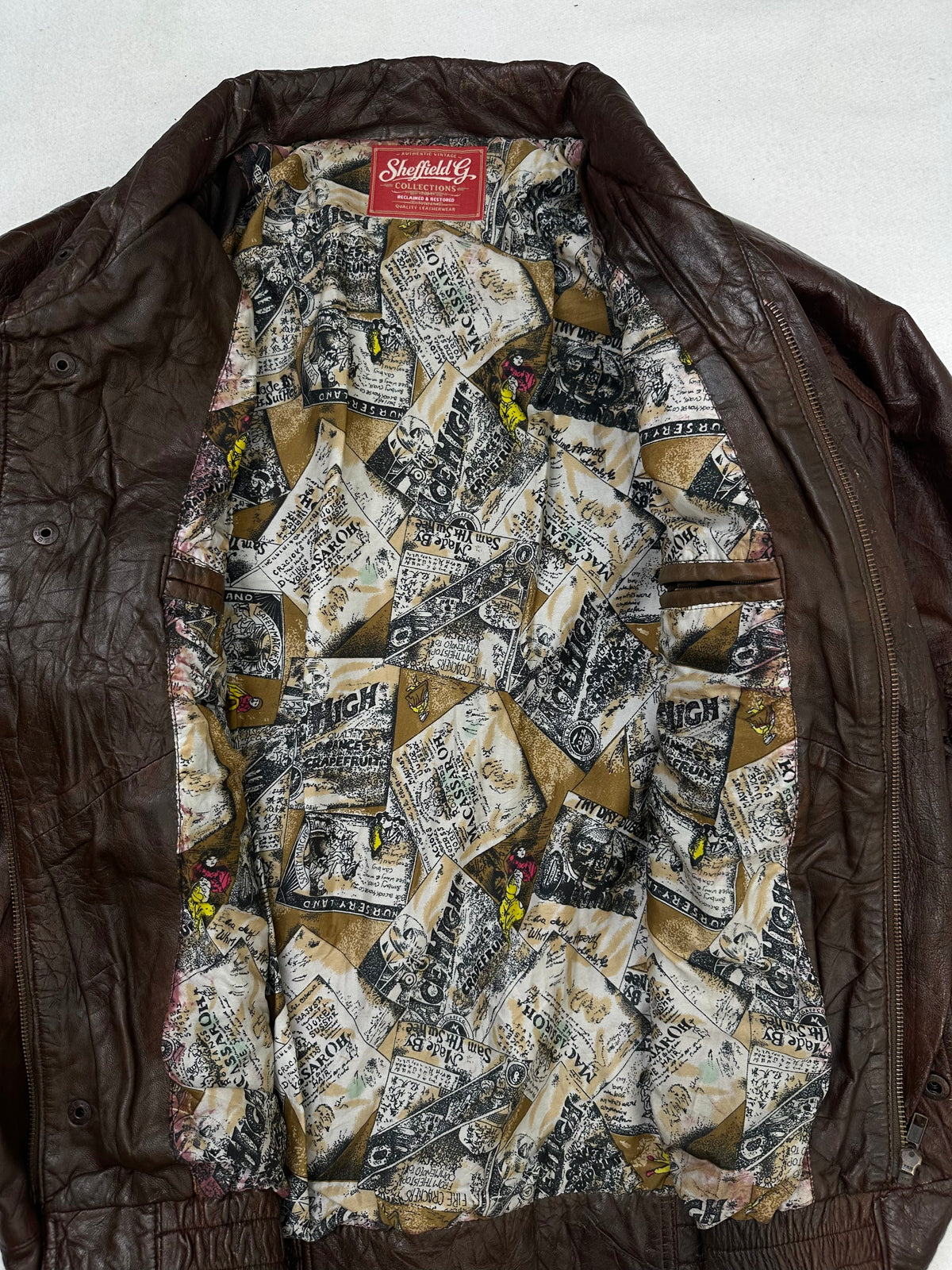 The size XL burgundy leather flight jacket opened to show the lining