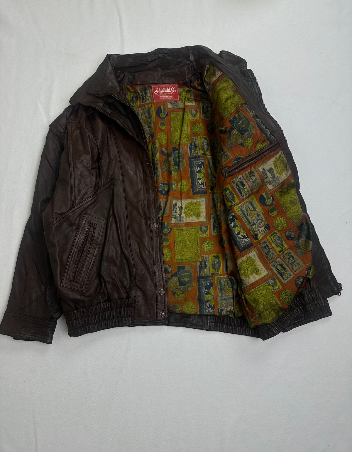 Printed lining revealed with the brown harrington opened at the front