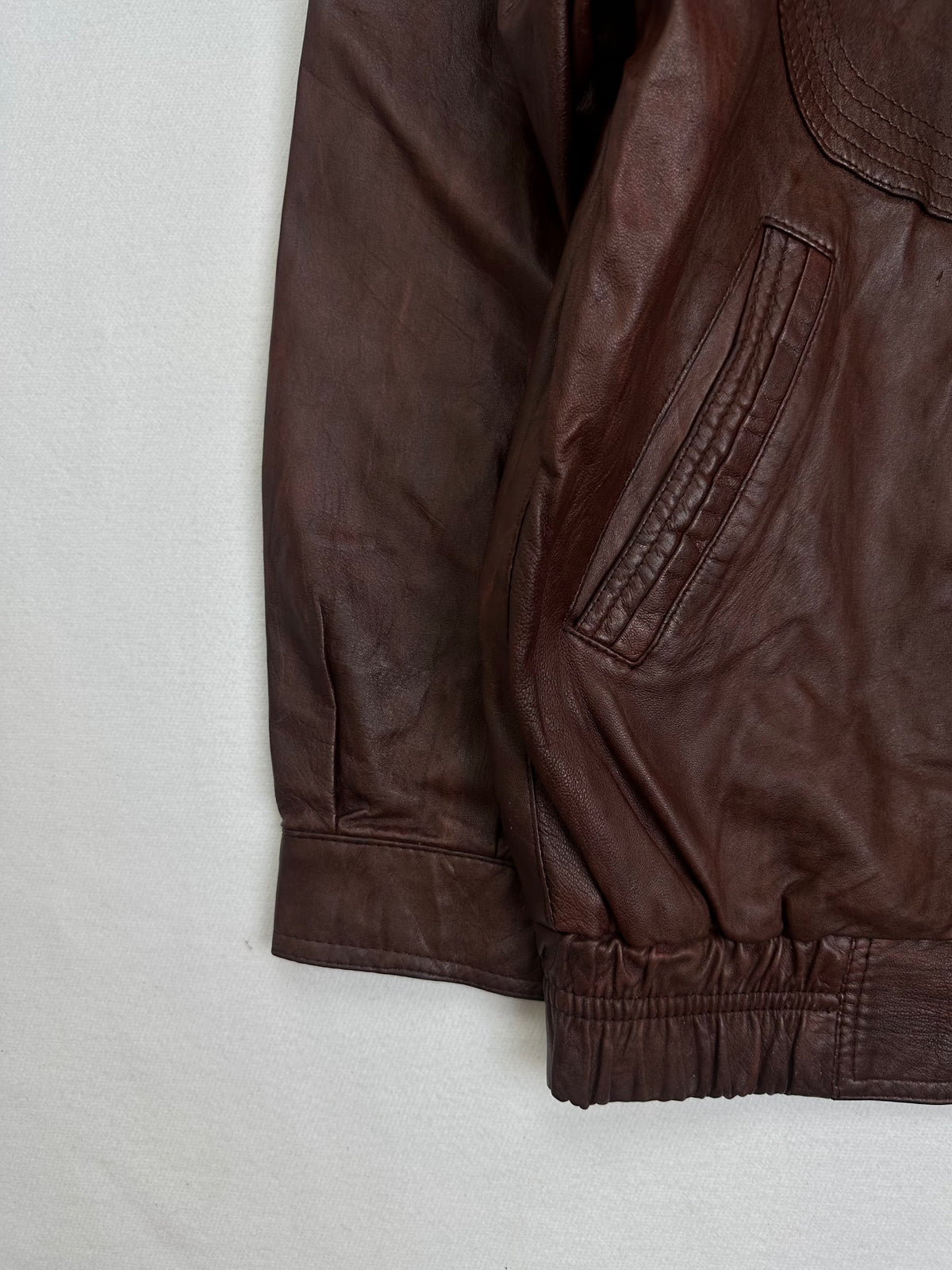 Close detail of the pockets and cuff on the size XL burgundy leather harrington jacket