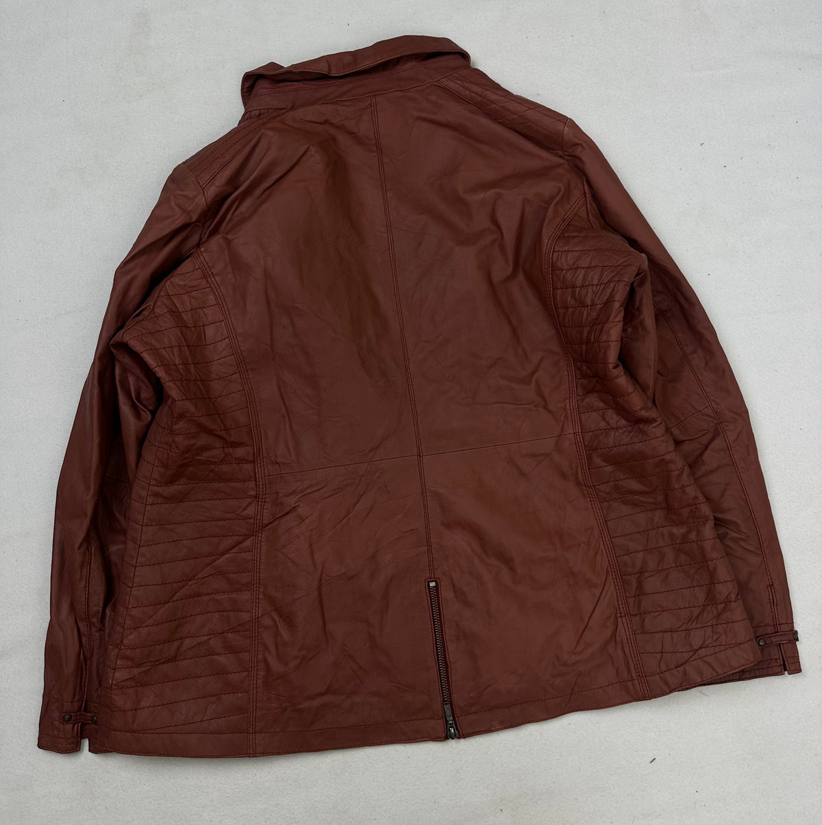 Back of the size XL burgundy leather vintage jacket, laid flat