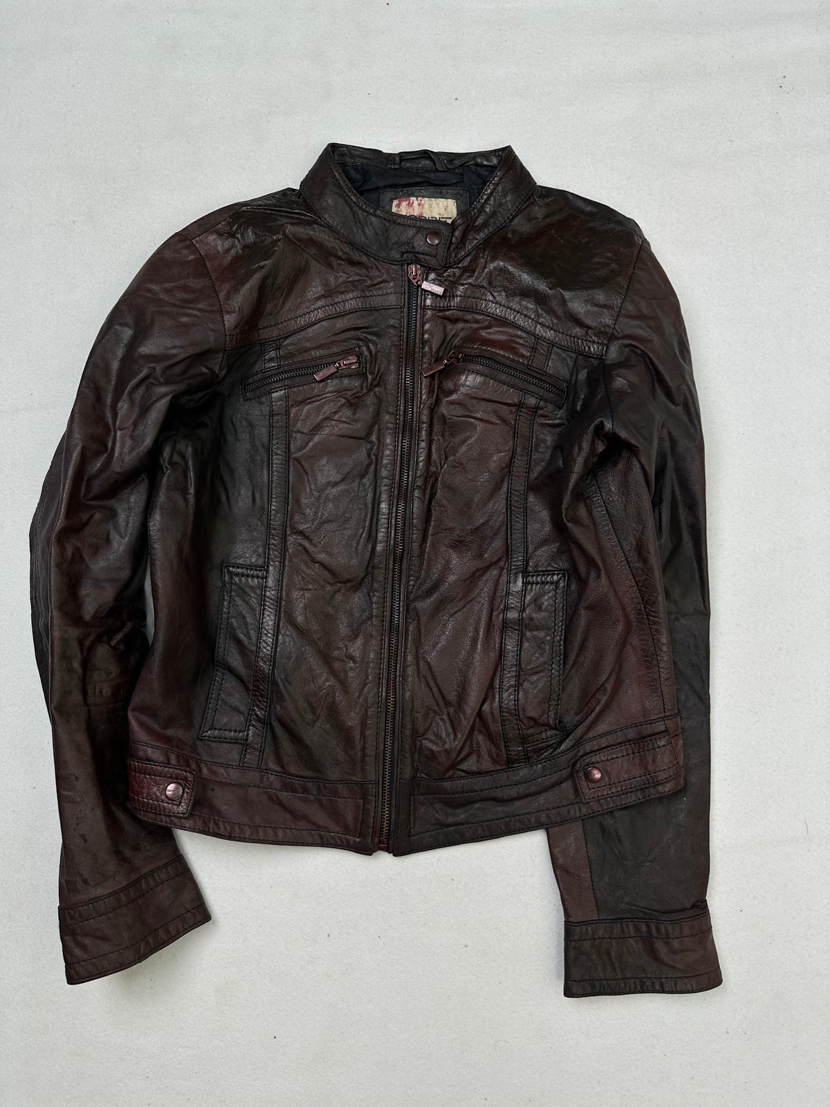 Front of the size S burgundy leather cafe racer jacket, laid flat and unedited