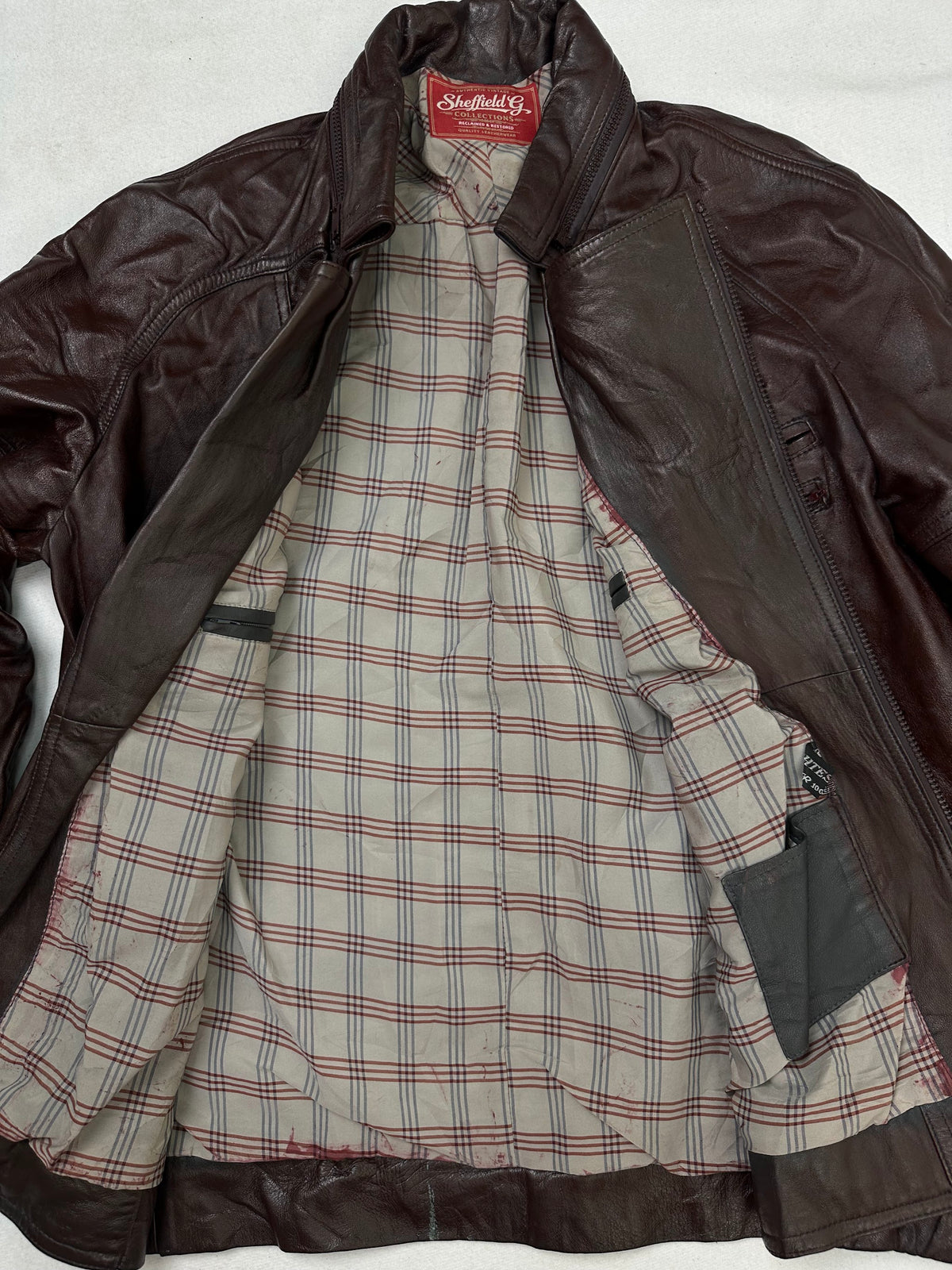 The size L burgundy leather biker jacket opened to show the lining