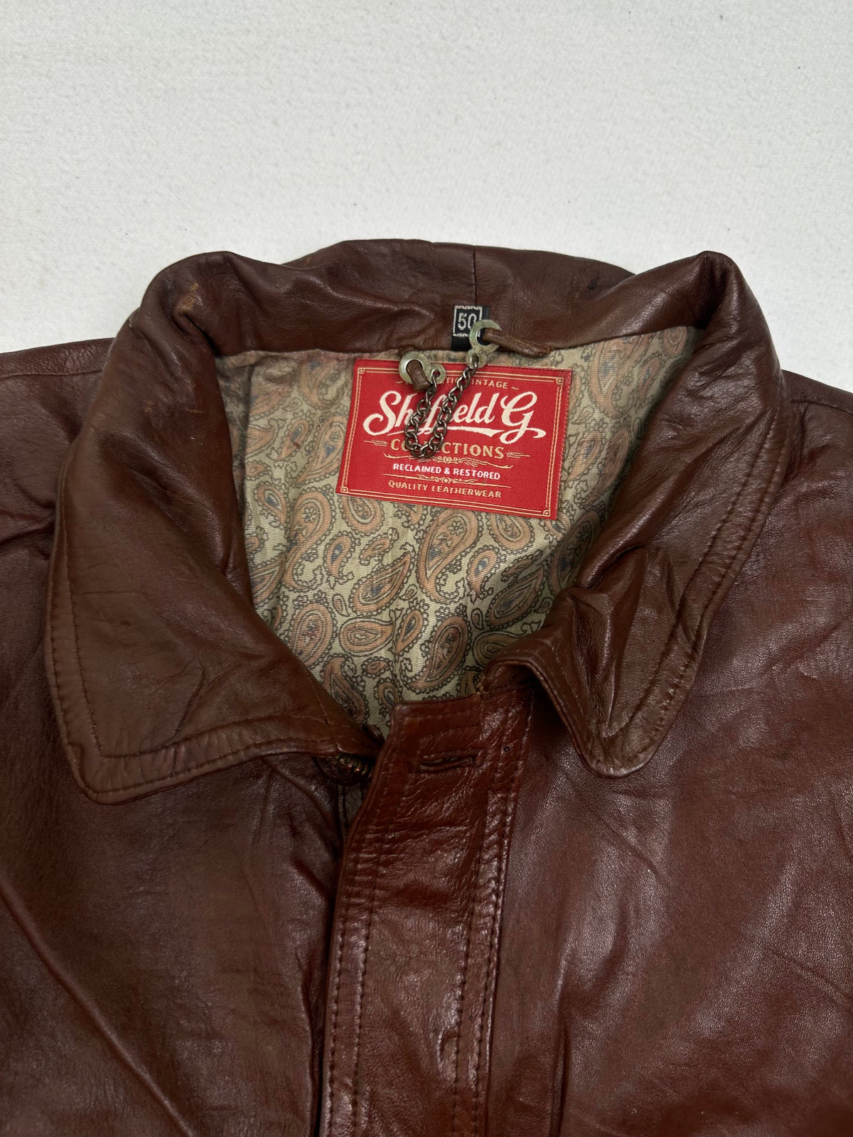 Collar and neck fastening on the burgundy leather harrington jacket