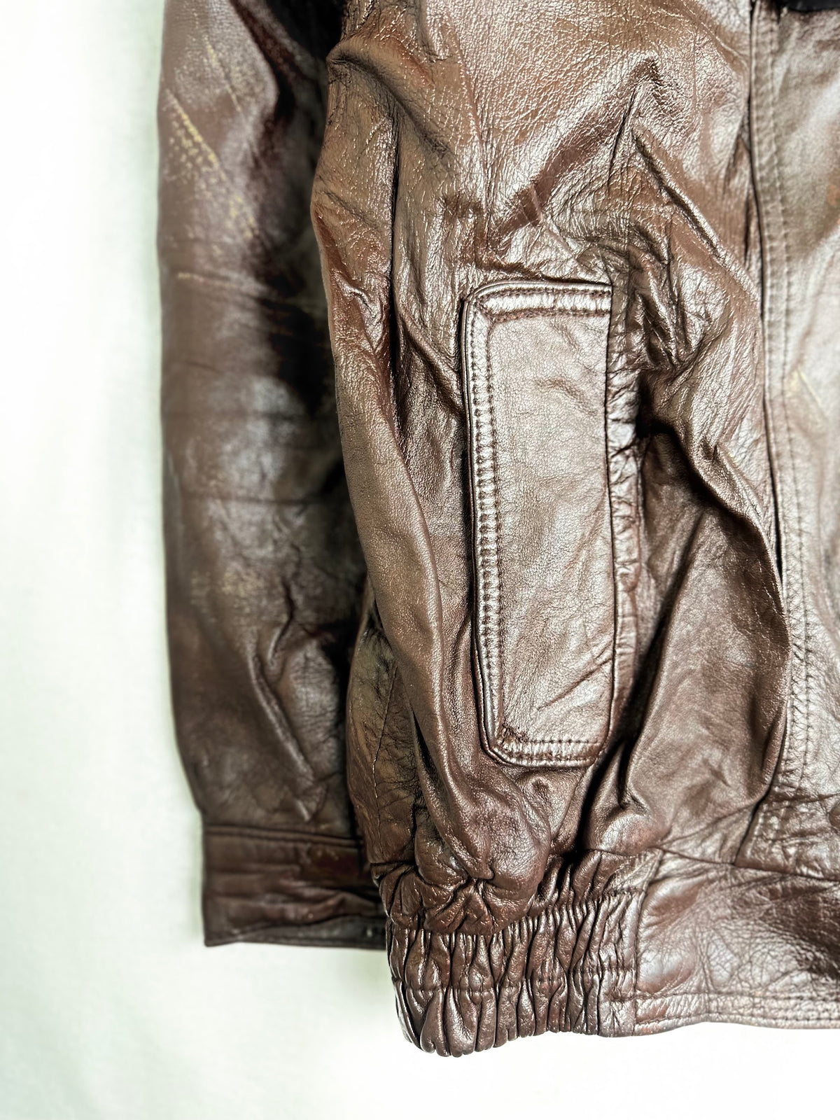 Shirred leather waistband with rubbing and darkening along the gathers