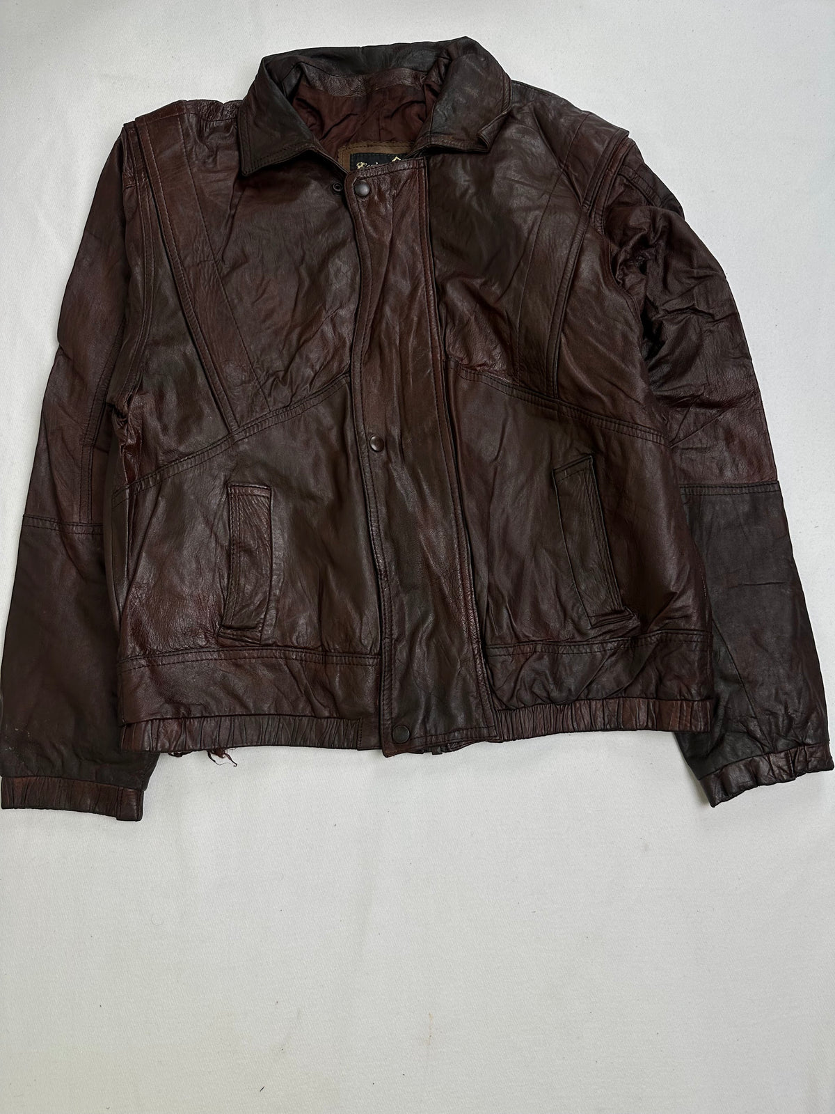 Back of the size L brown harrington jacket laid flat