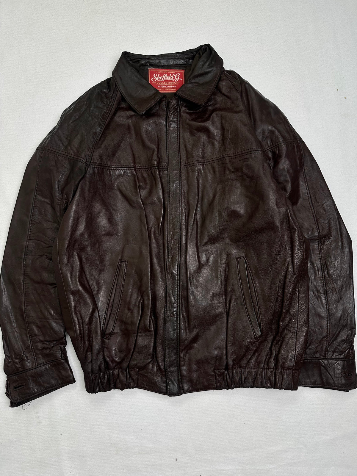 Front of the size M burgundy leather harrington jacket, laid flat and unedited