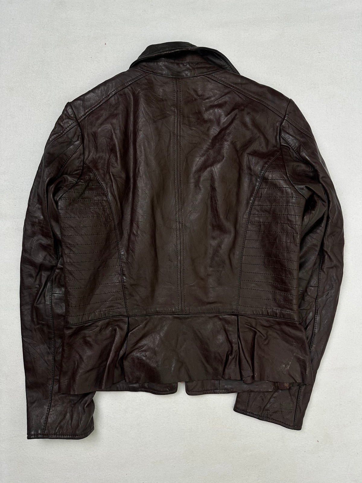 Back of the size XS burgundy leather biker jacket, laid flat