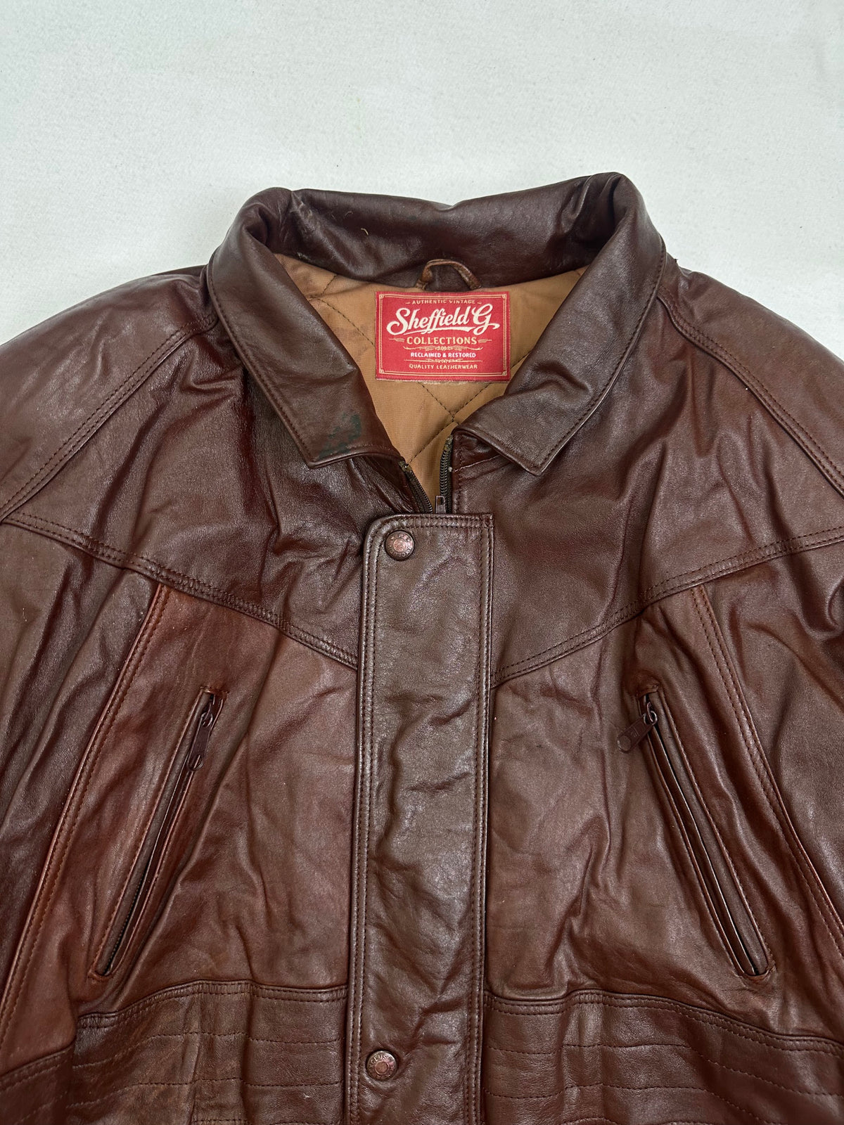 Inside of the collar on the size L burgundy leather vintage jacket