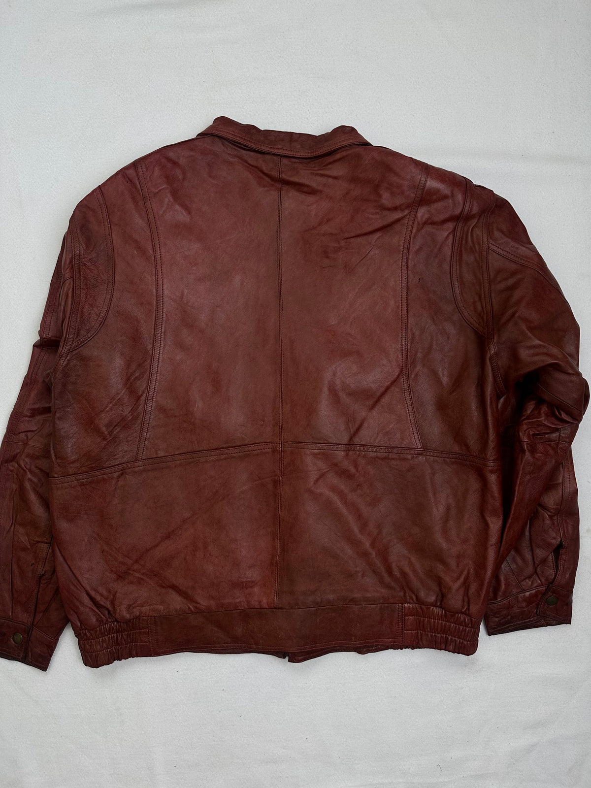 Back of the size XL burgundy leather harrington jacket, laid flat