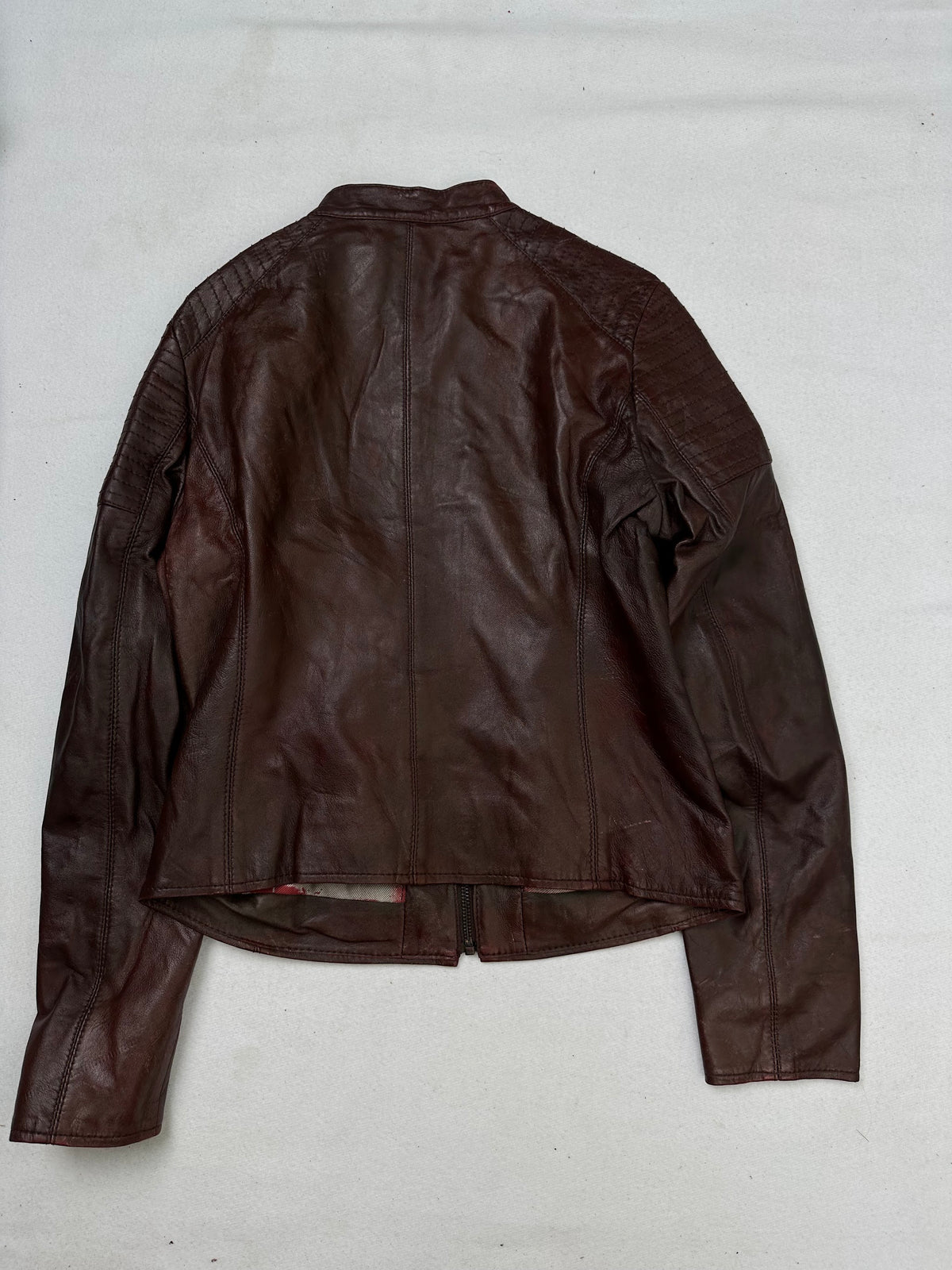 Back of the size XS burgundy leather cafe racer jacket, laid flat
