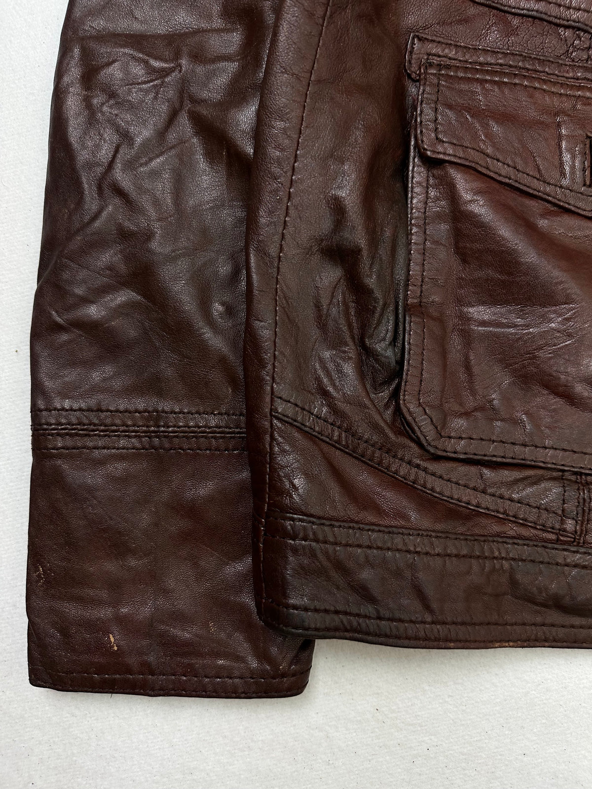 Close detail of the pockets and cuff on the size L burgundy leather field jacket