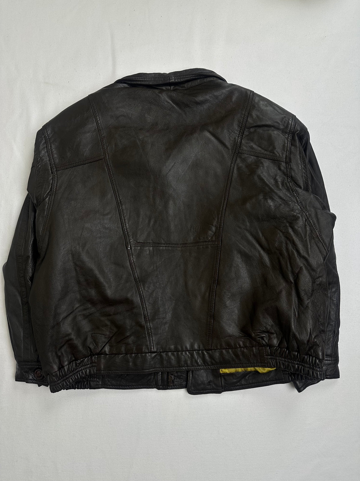 Pointed shirt collar and its snap tab above the covered placket