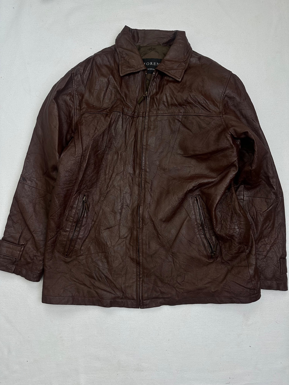 Front of the size L burgundy leather vintage jacket, laid flat and unedited