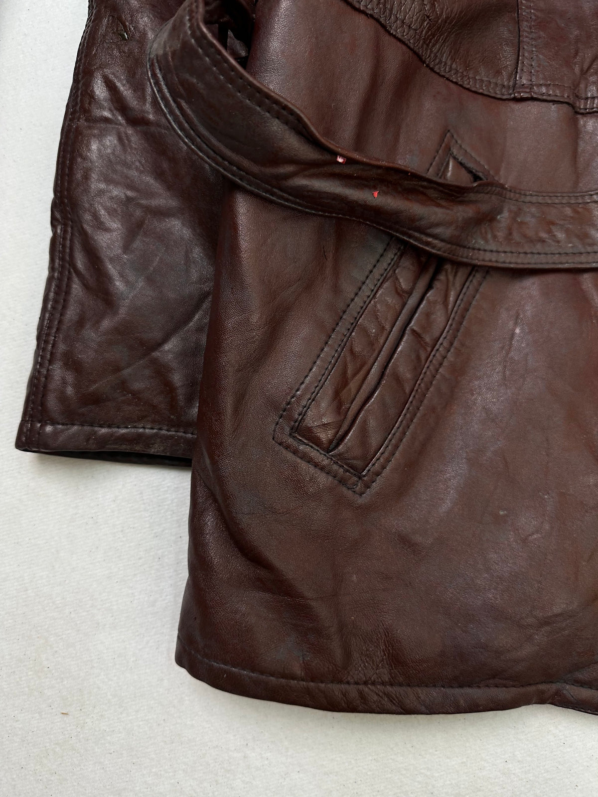 Close detail of the pockets and cuff on the size M burgundy leather vintage jacket