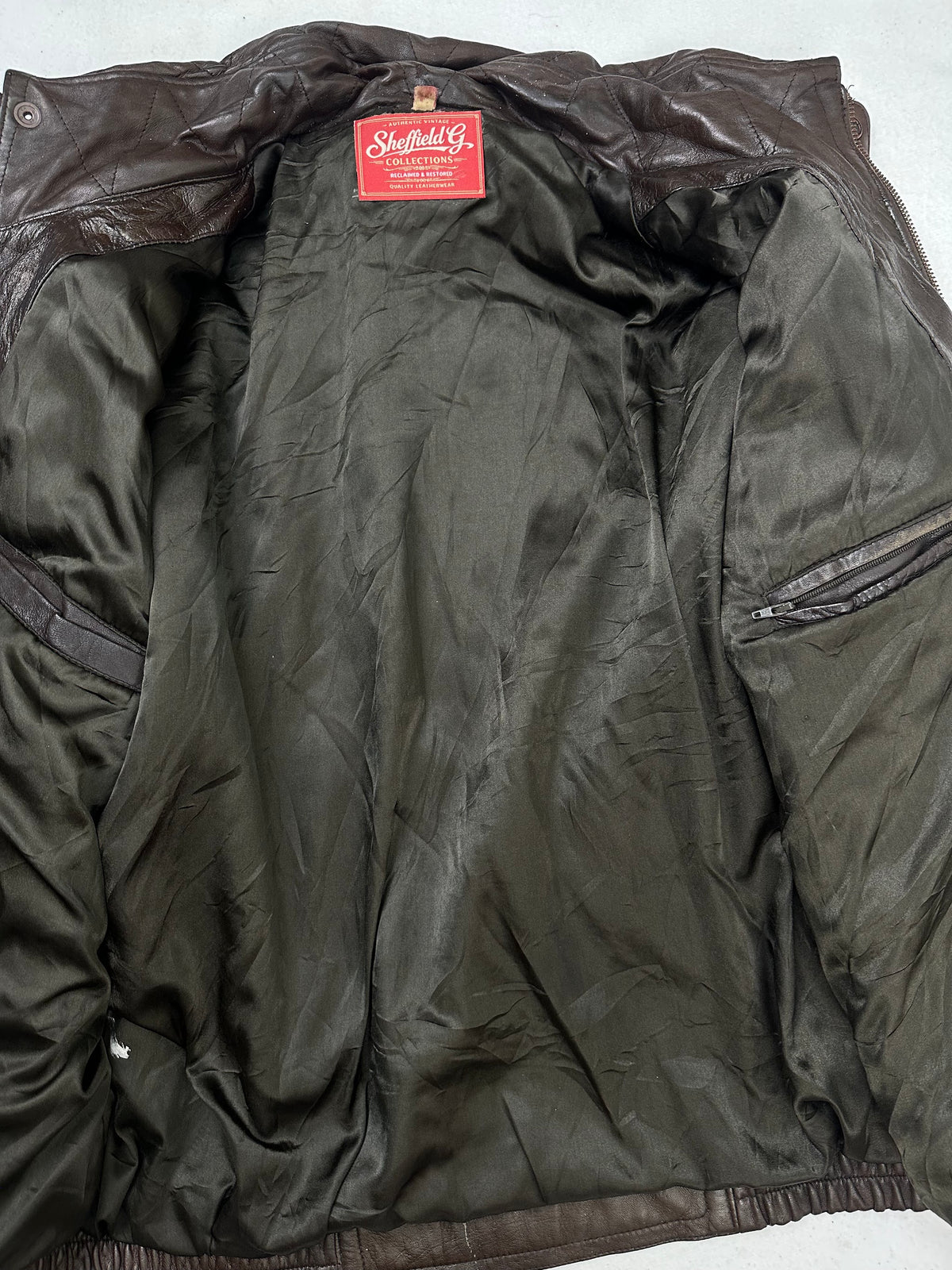 The size L burgundy leather flight jacket opened to show the lining