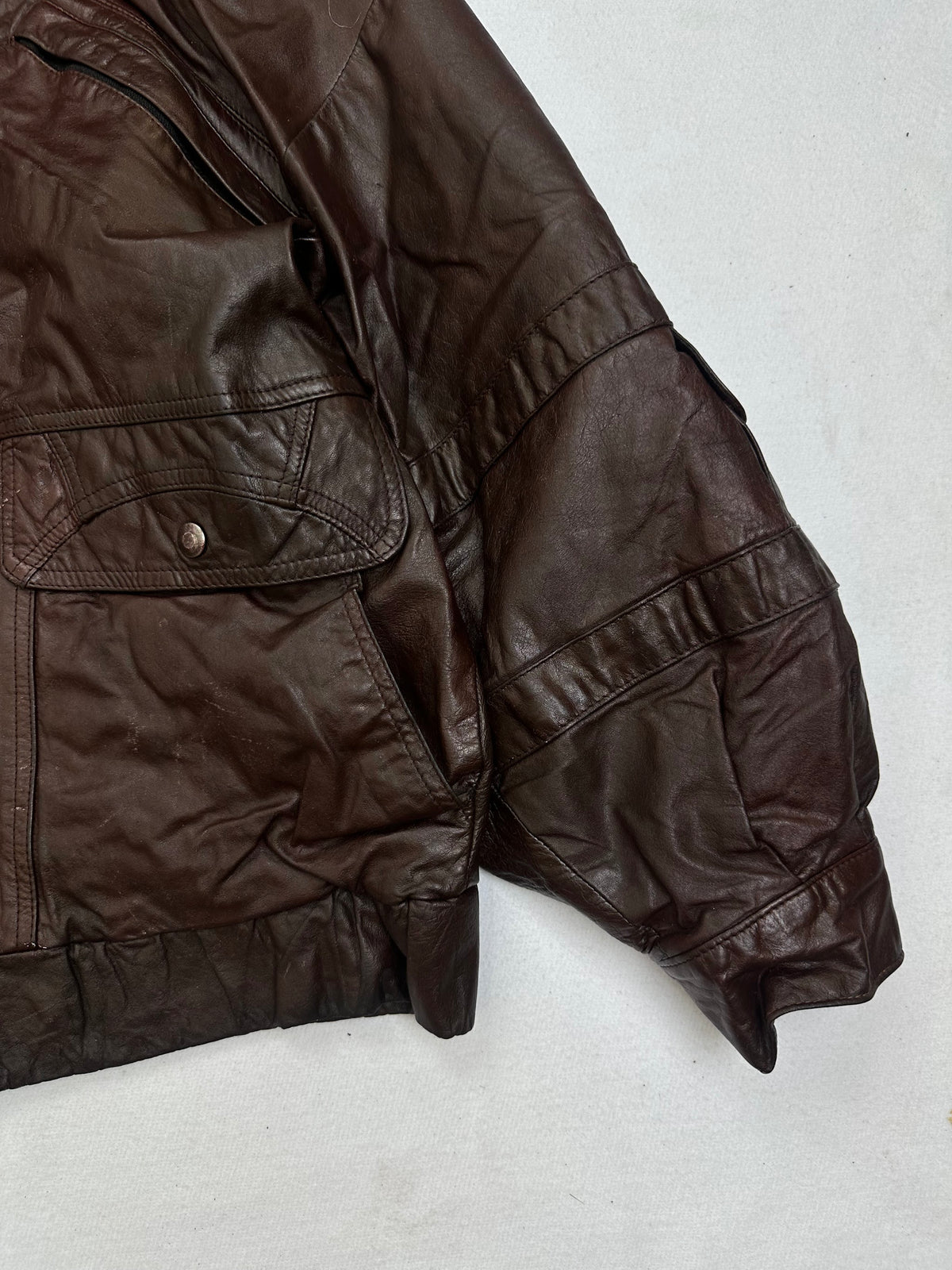 Side pocket and hem of the size M burgundy leather flight jacket, up close