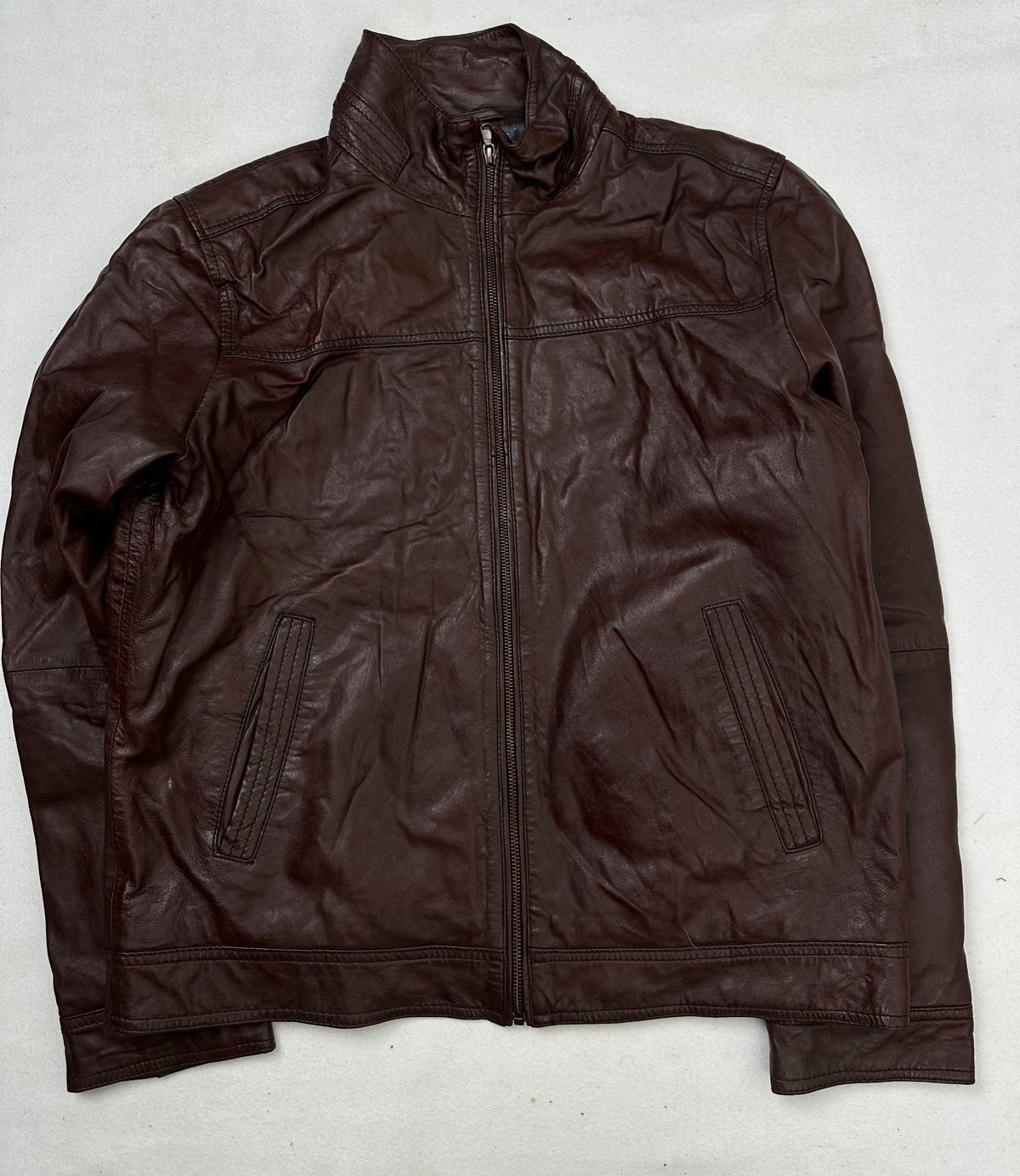 Front of the size L burgundy leather cafe racer jacket, laid flat and unedited