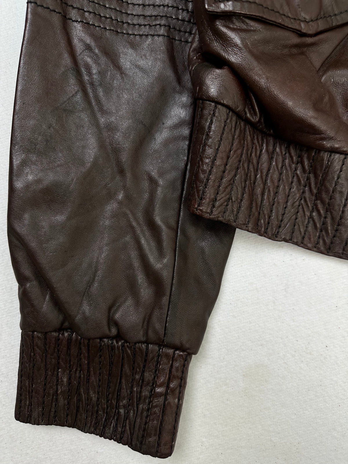 Close detail of the pockets and cuff on the size S burgundy leather flight jacket