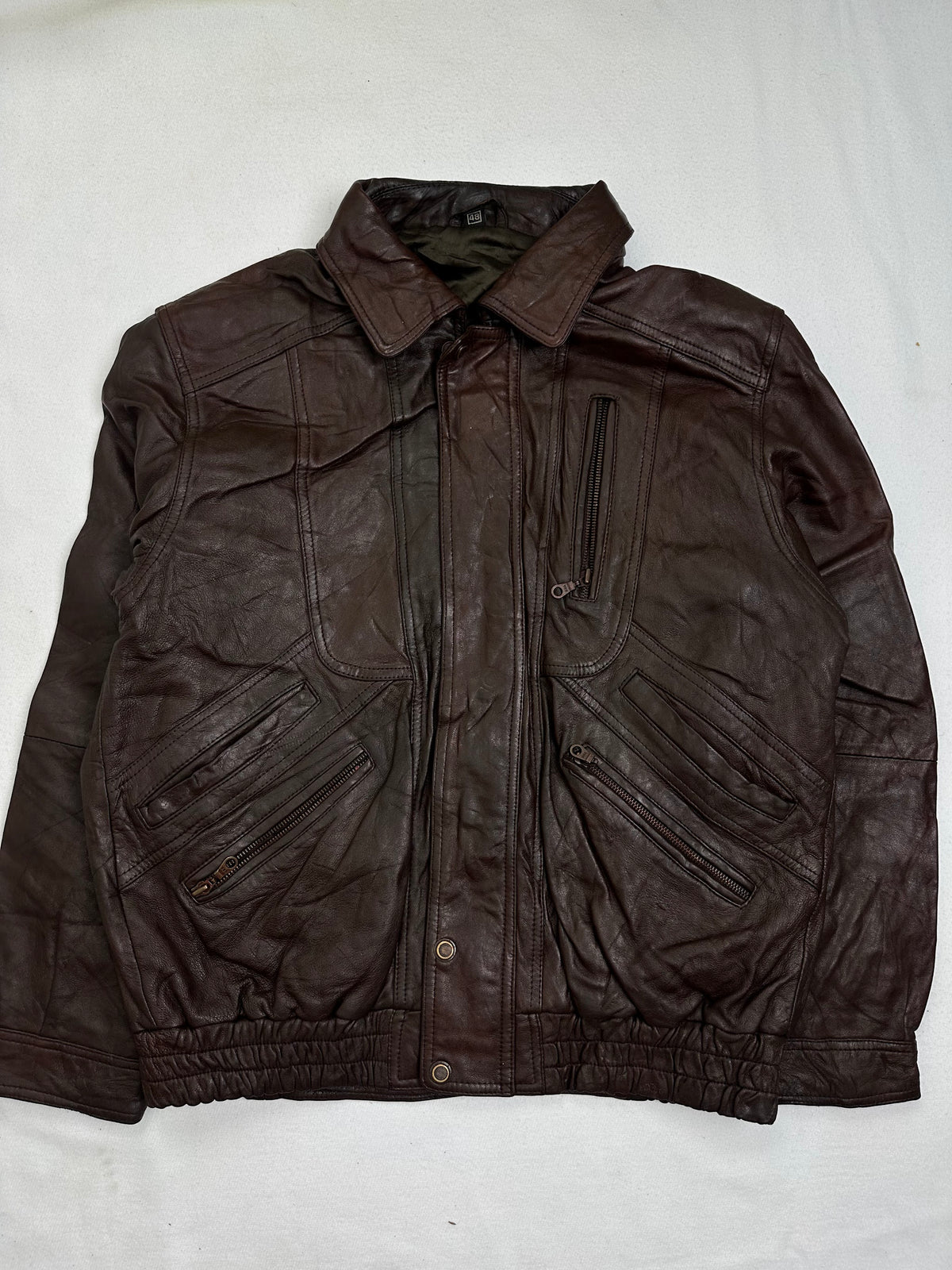 Front of the size M burgundy leather vintage jacket, laid flat and unedited
