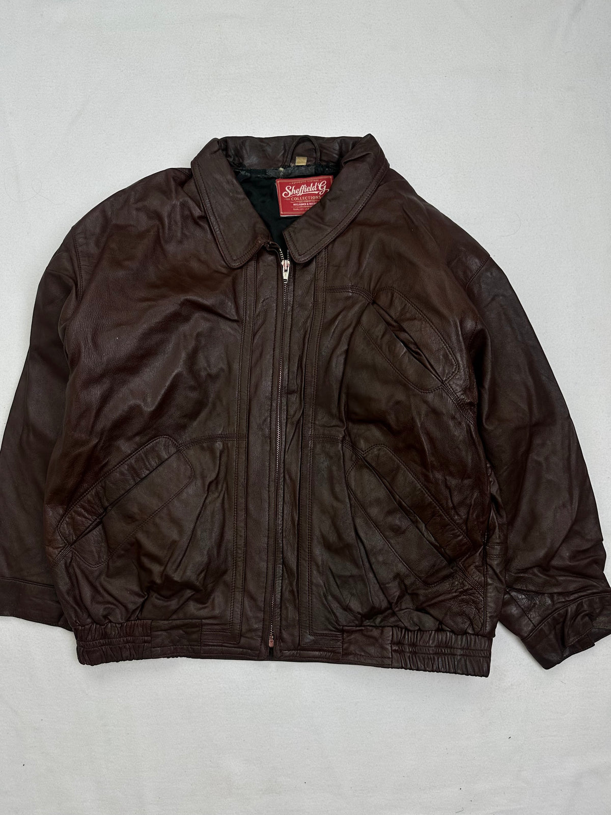 Front of the size L burgundy leather flight jacket, laid flat and unedited