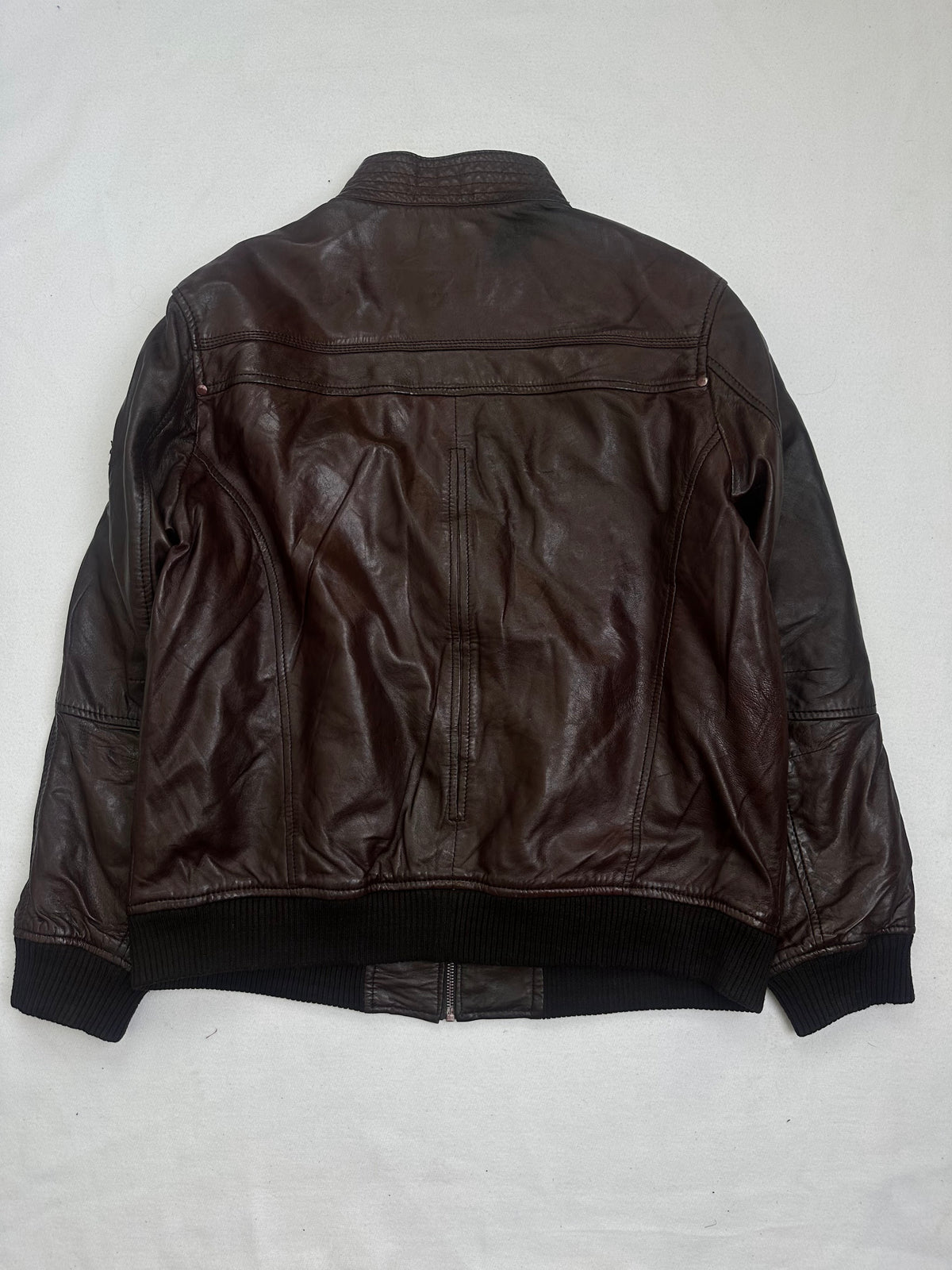 Back of the size L burgundy leather bomber jacket, laid flat
