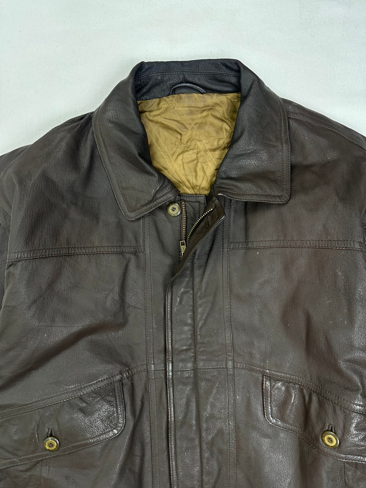 Gold quilted lining shown at the neck with the jacket open