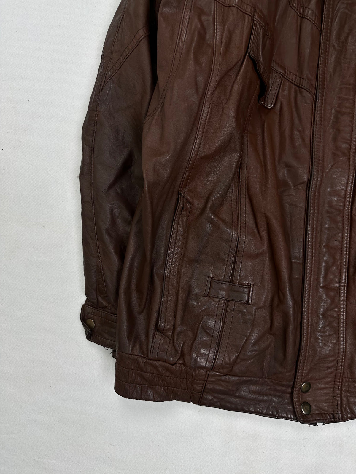 Close detail of the pockets and cuff on the size XL burgundy leather vintage jacket